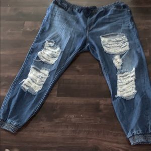 Long cinched ripped blue jeans